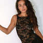 Model in black lace dress with black star shaped reusable nipple covers
